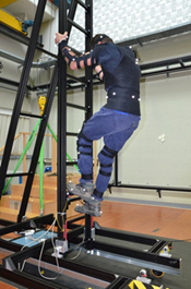 Test subject equipped with the CUELA measurement system on a ladder in the laboratory